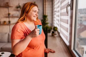 woman-drinks-coffee-at-window